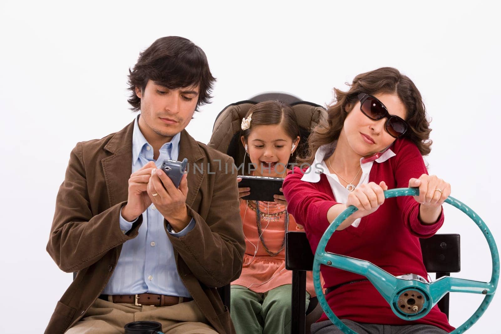 Studio portrait of distracted family in imaginary car