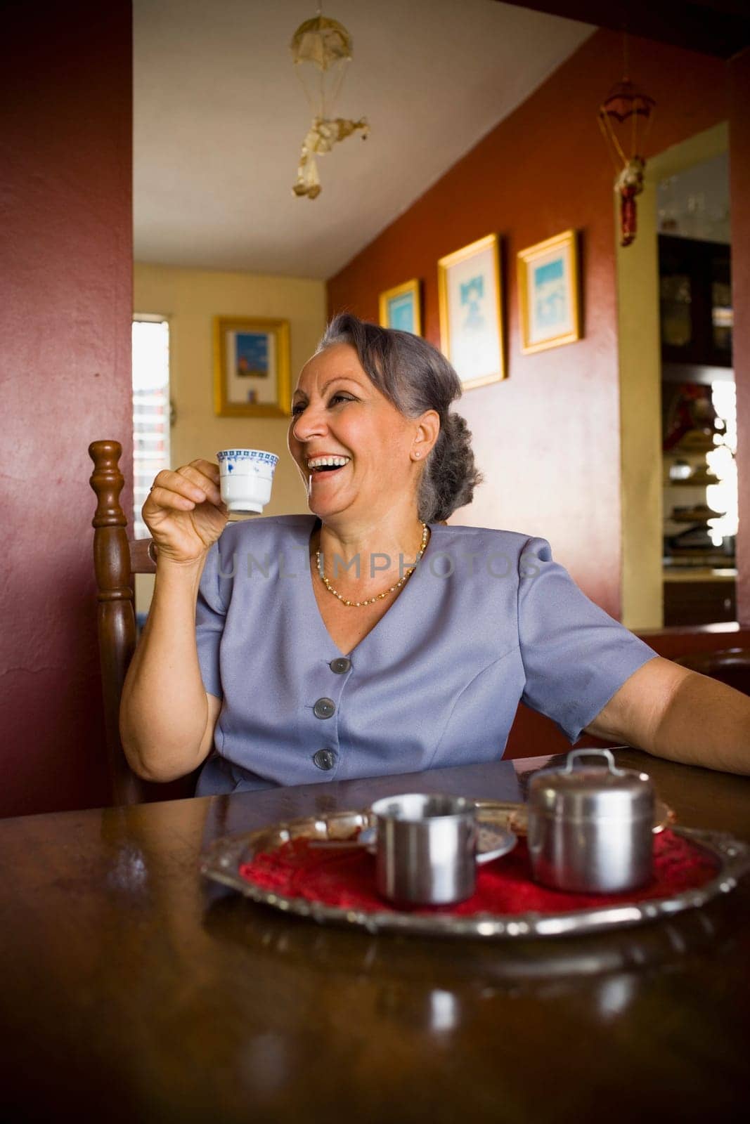 Mature woman holding a cup of tea and smiling