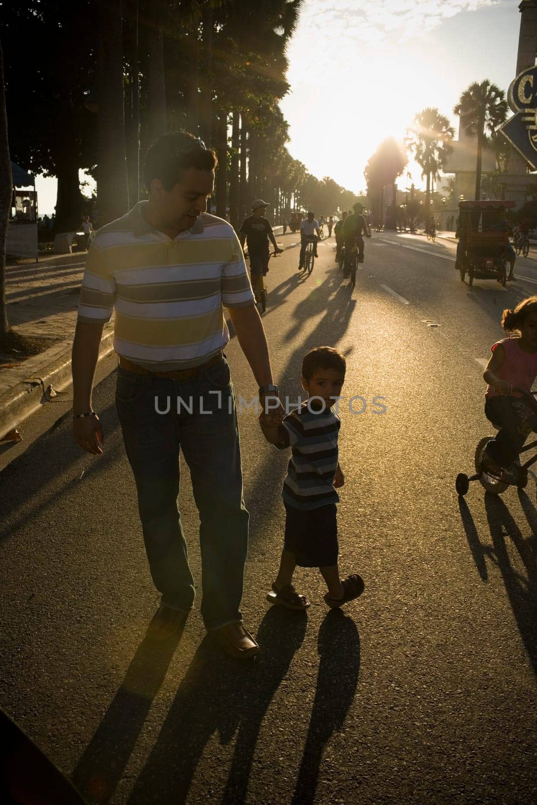 Mid adult man and his son walking on the road, Malecon, Santo Domingo, Dominican Republic