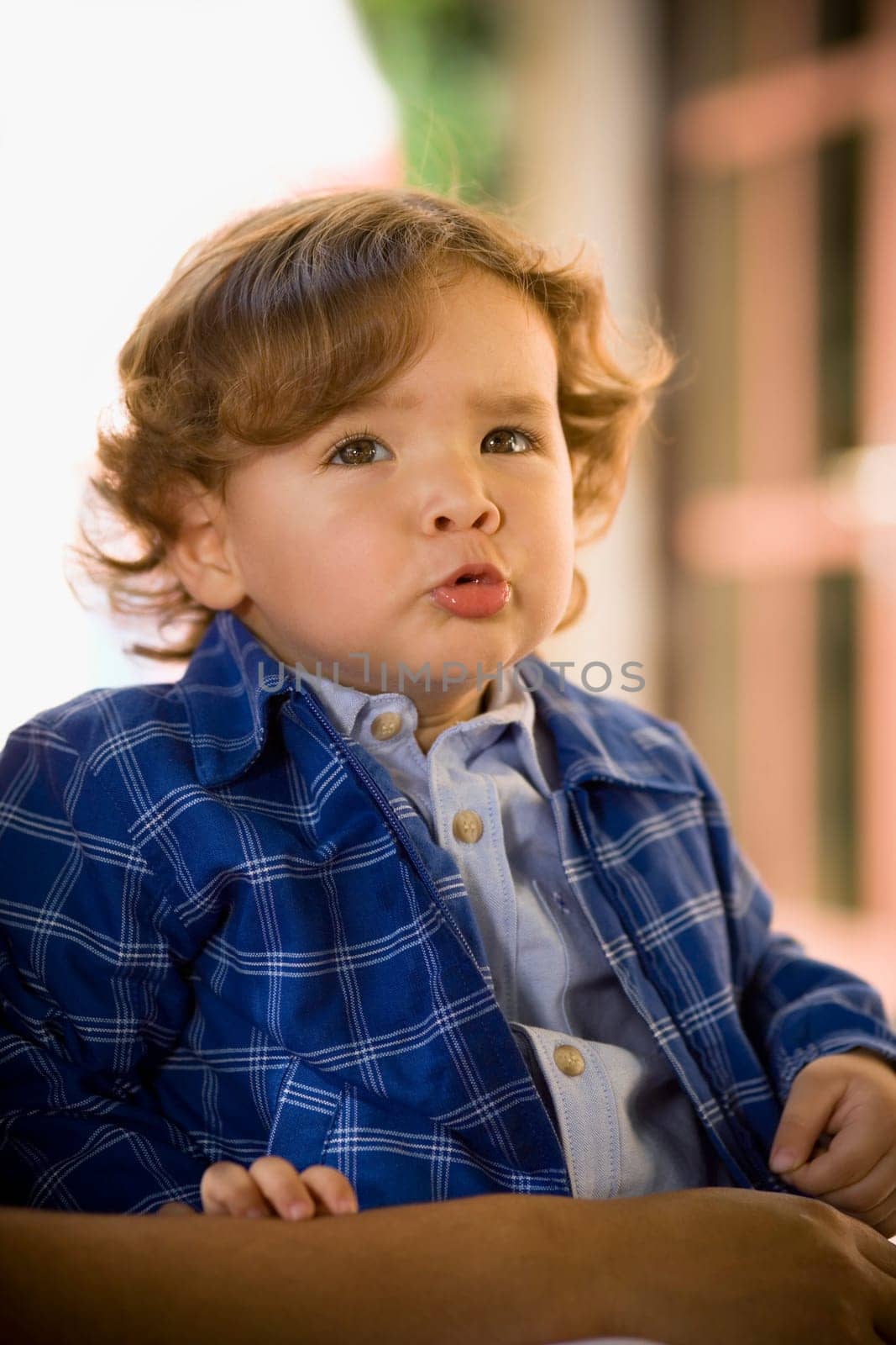 Close-up of a baby boy looking displeased