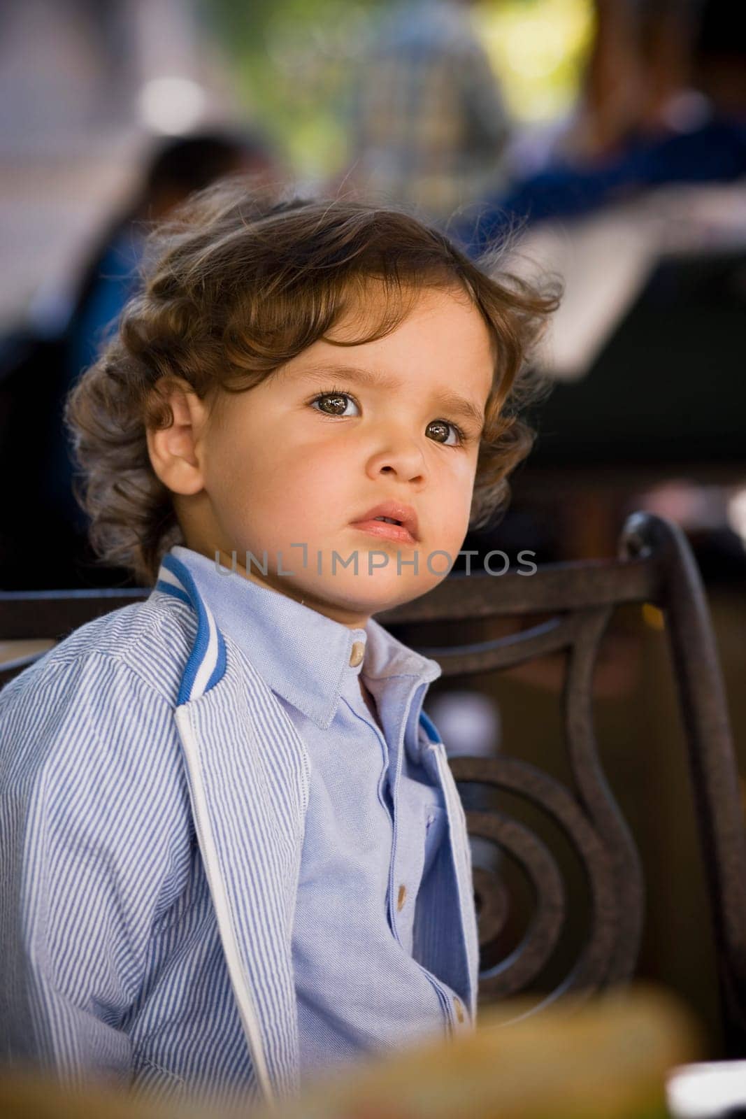 Close-up of a baby boy sitting in a restaurant