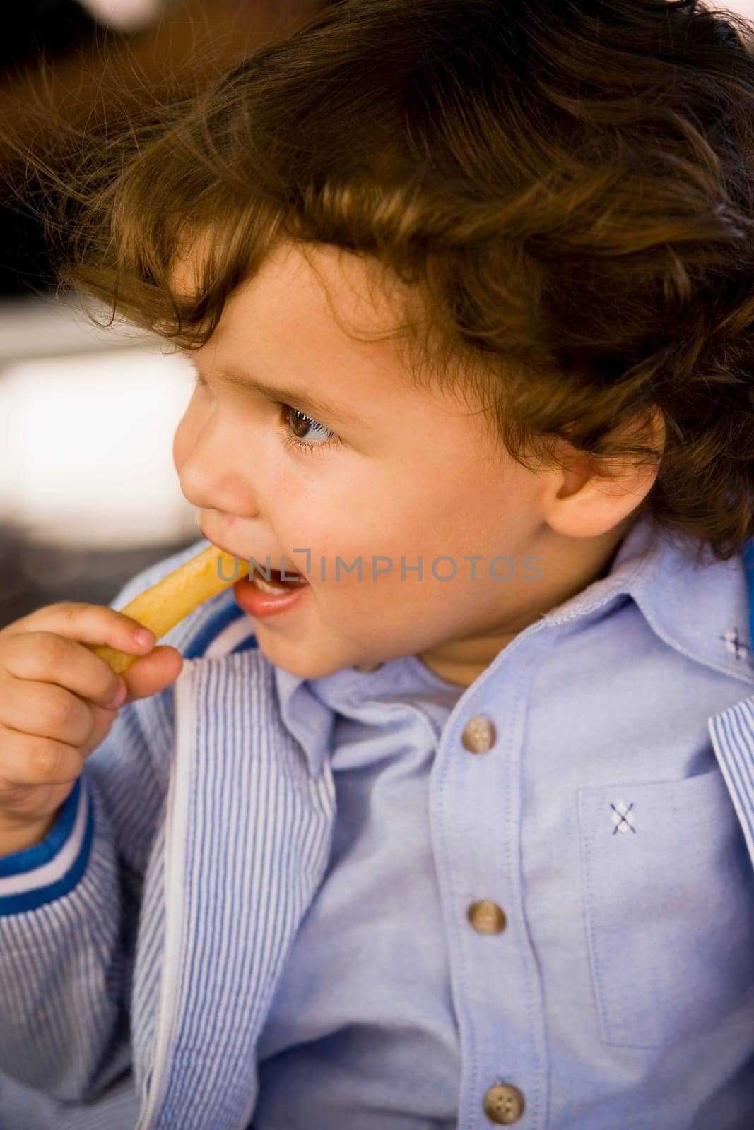 Close-up of a baby boy eating snacks