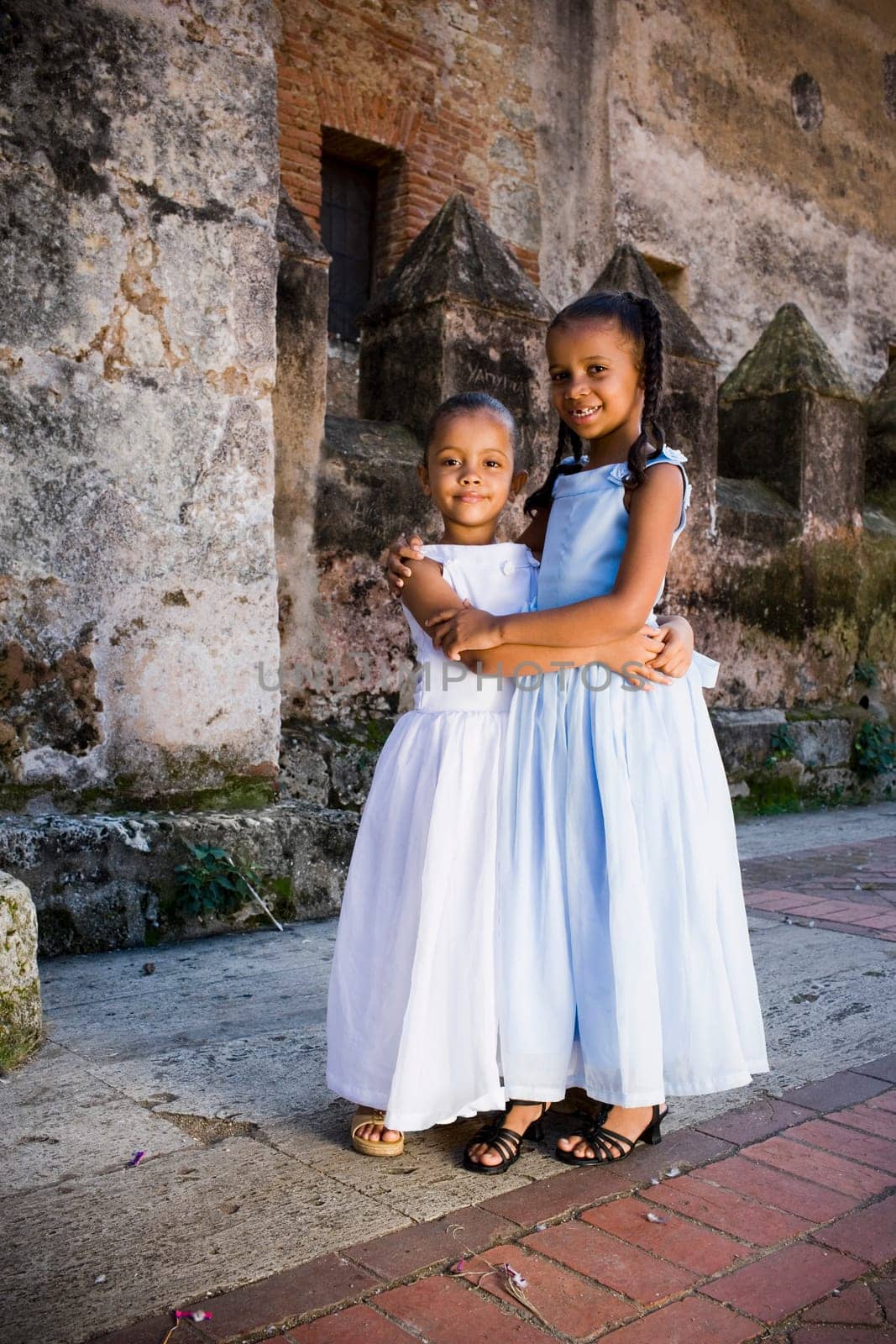 Portrait of two girls smiling and hugging each other