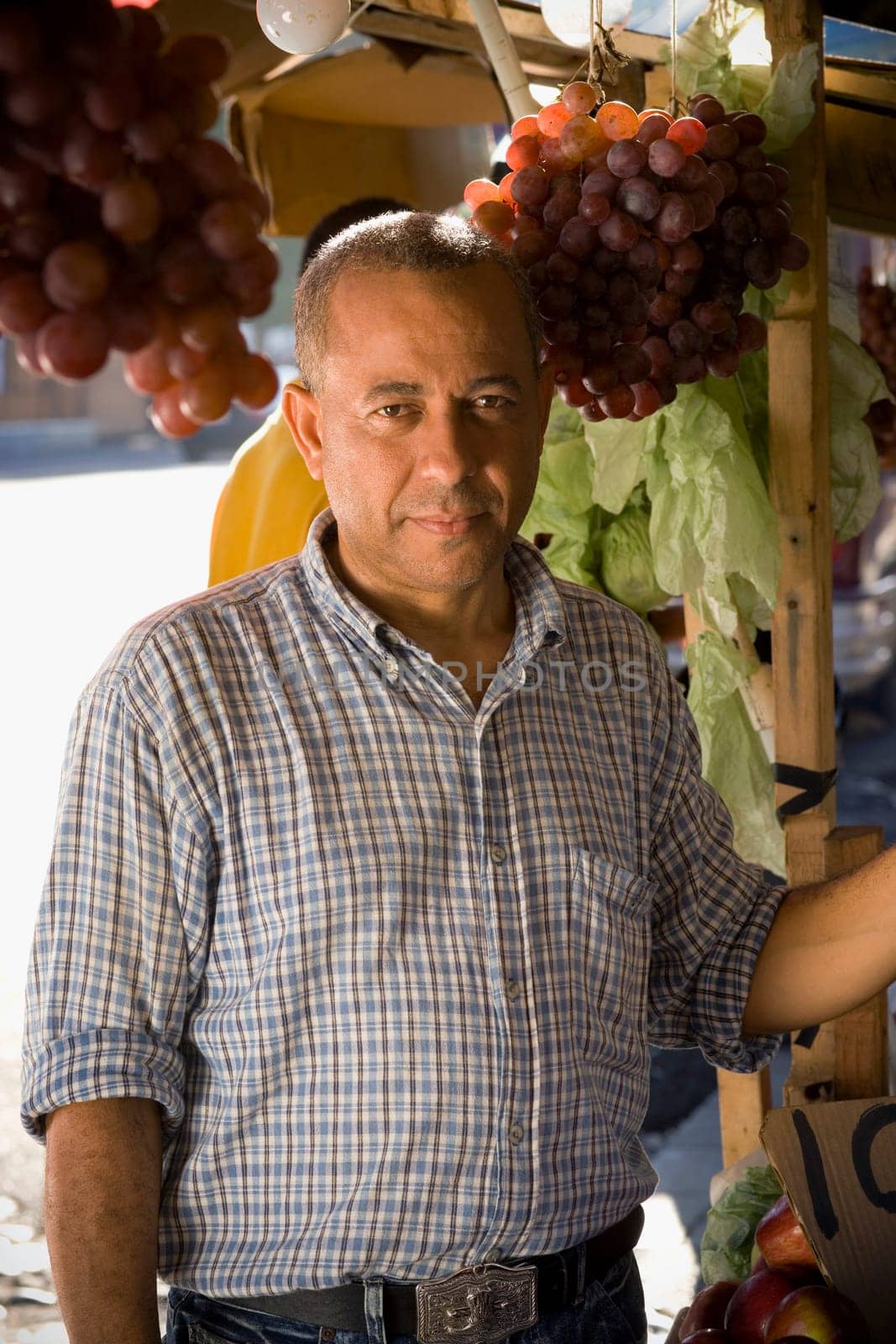 Portrait of a mature man in front of a market stall, Santo Domingo, Dominican Republic