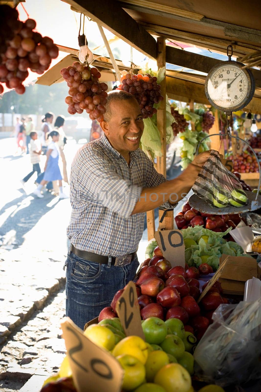 Portrait of a fruit seller weighing fruit, Santo Domingo, Dominican Republic