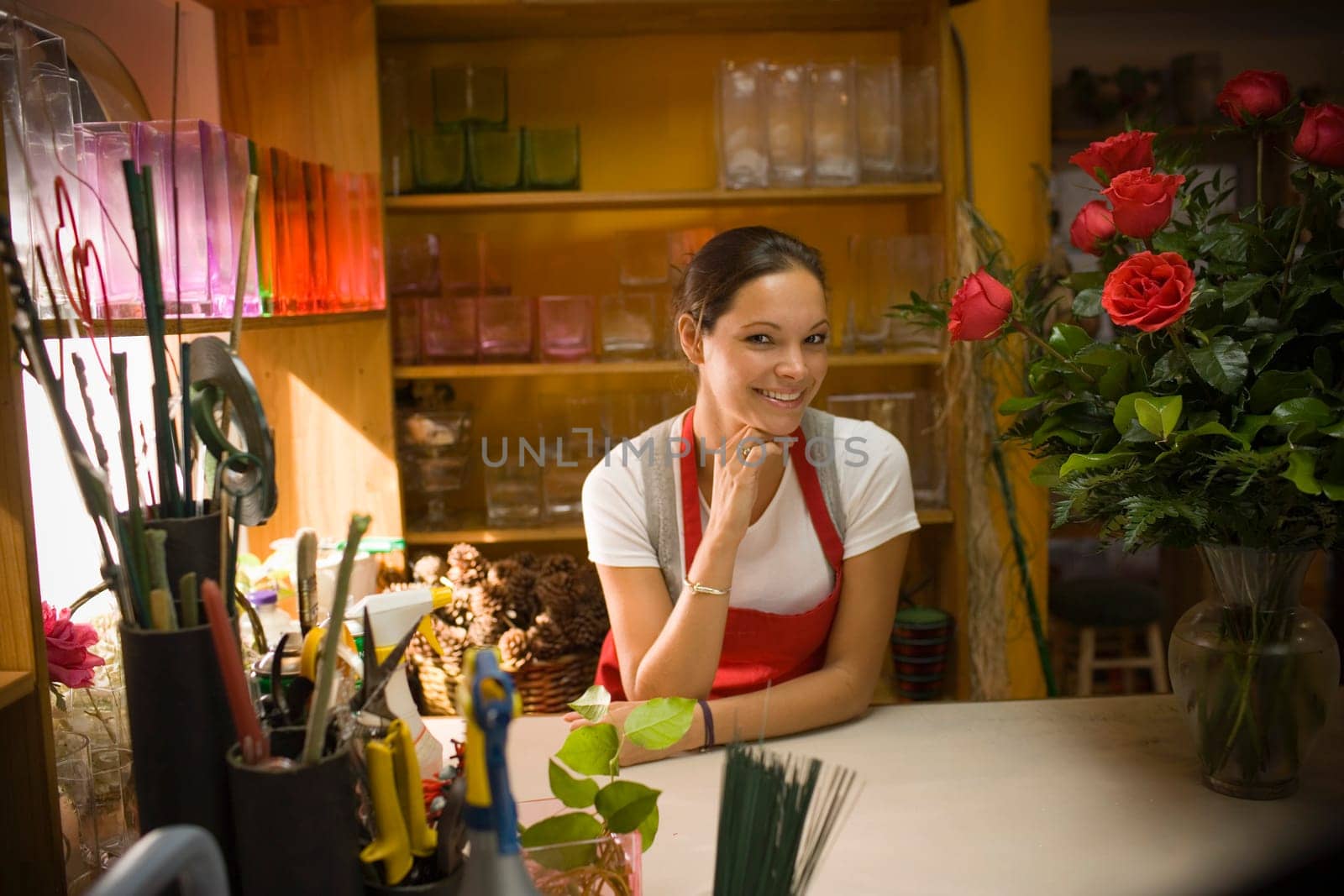 Young woman in flower shop with rose arrangement