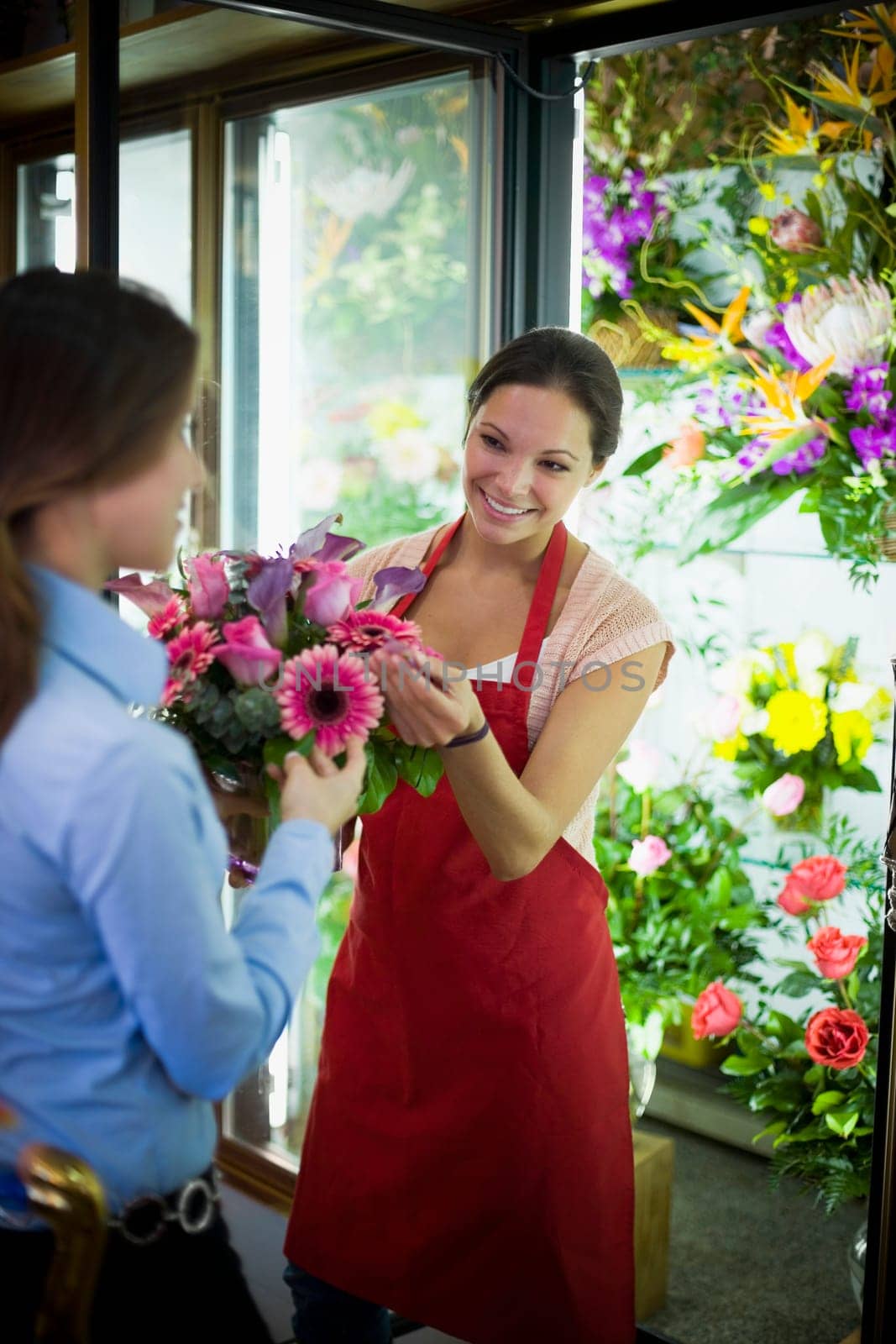 Flower shop owner helping customer