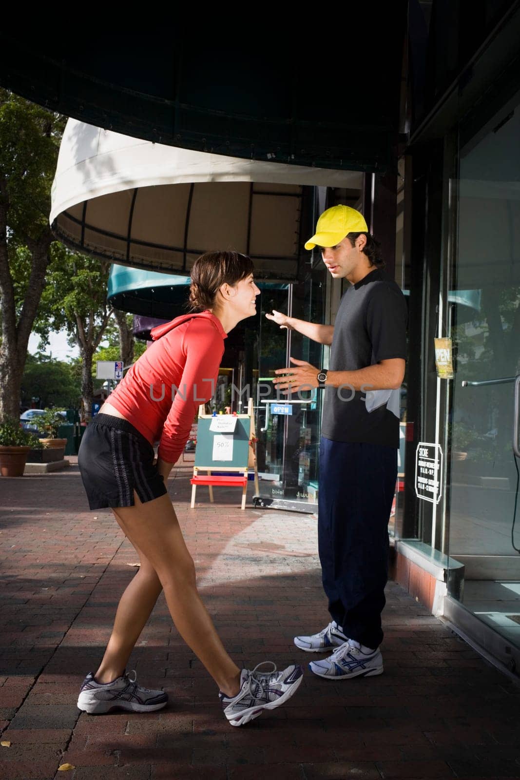 Young woman exercising with physical trainer