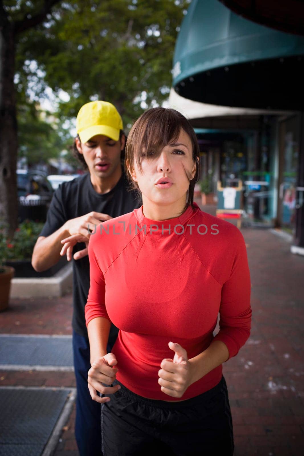 Young woman exercising with physical trainer