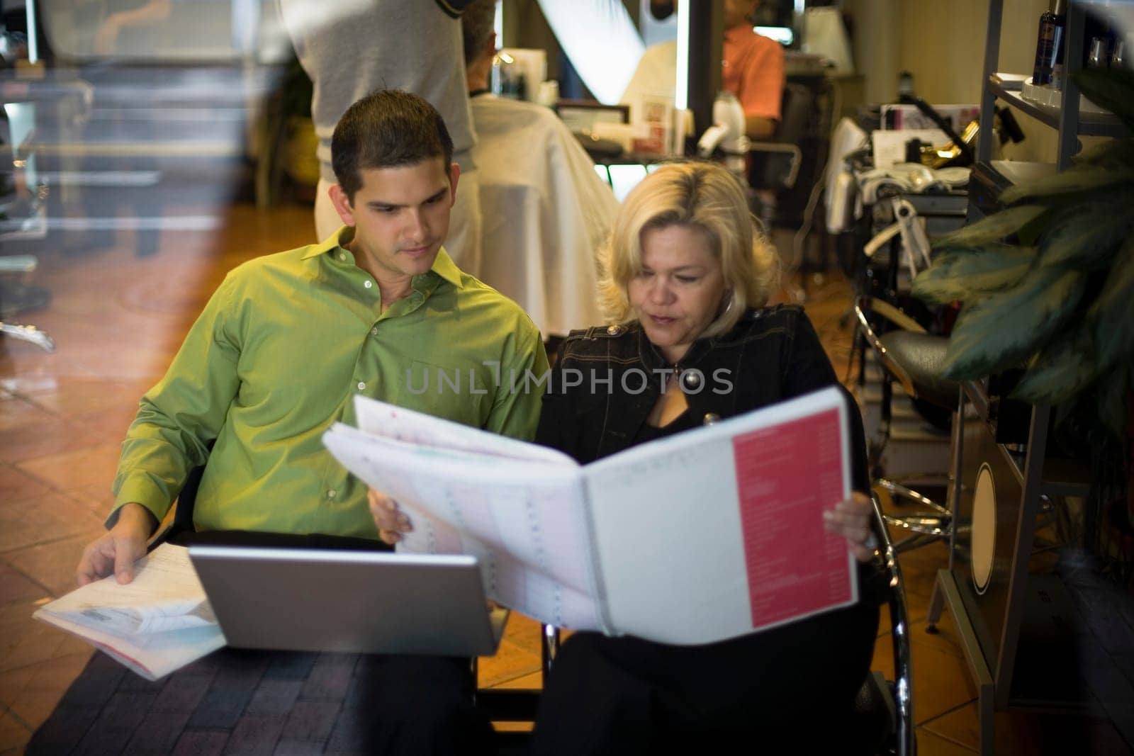 Salon owner discusses business with partner
