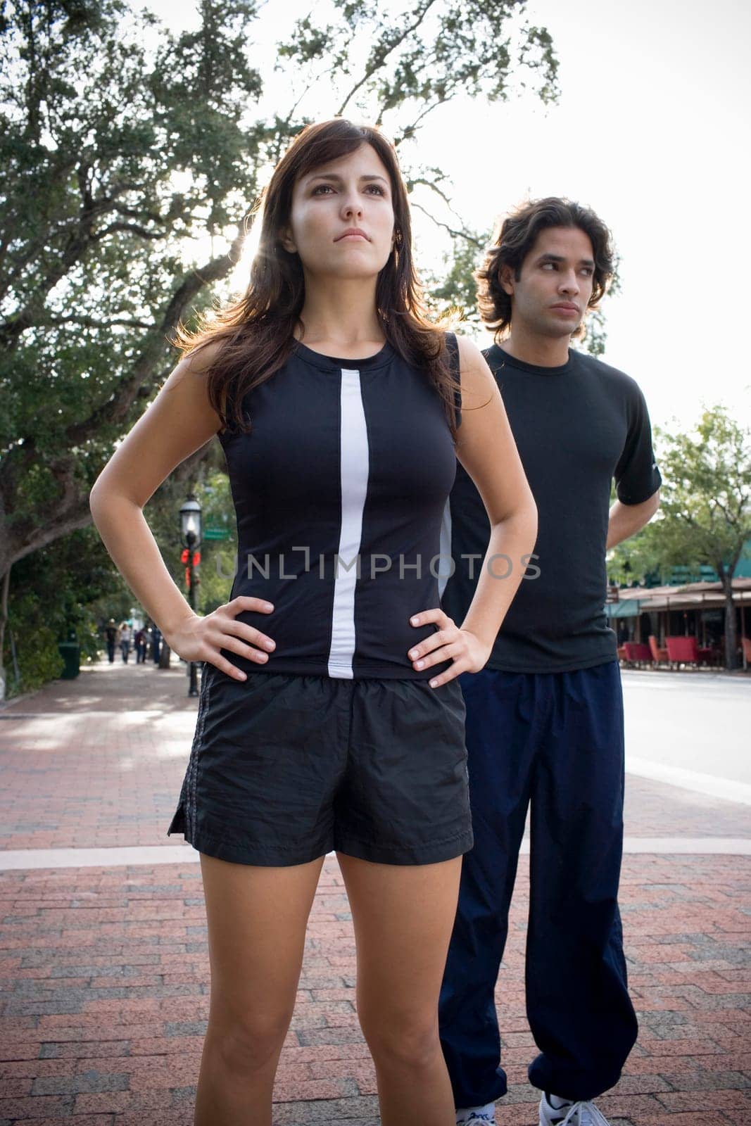 Young man jogging with physical trainer