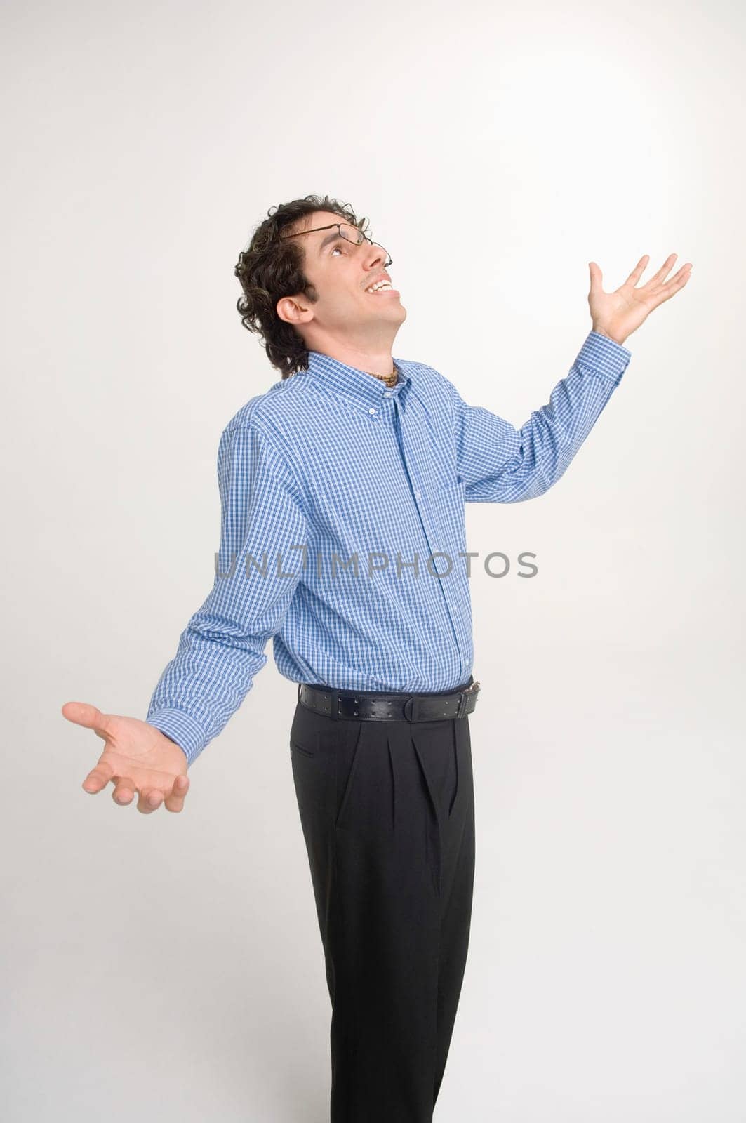 Man wearing crooked glasses gesturing