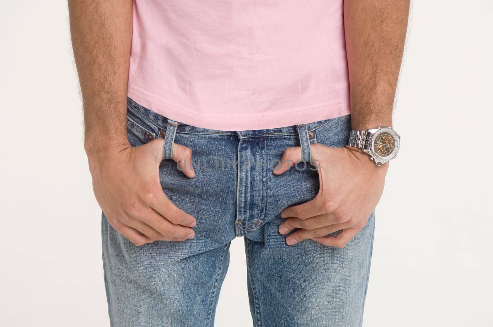 Man with fingers looped in belt loops