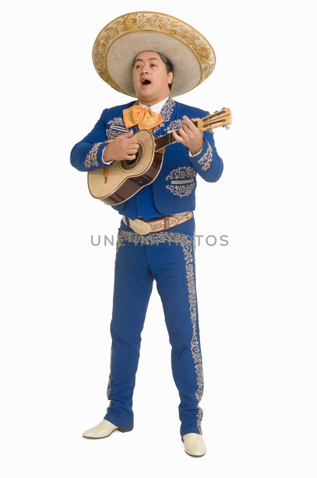 Portrait of Mariachi playing guitar and singing
