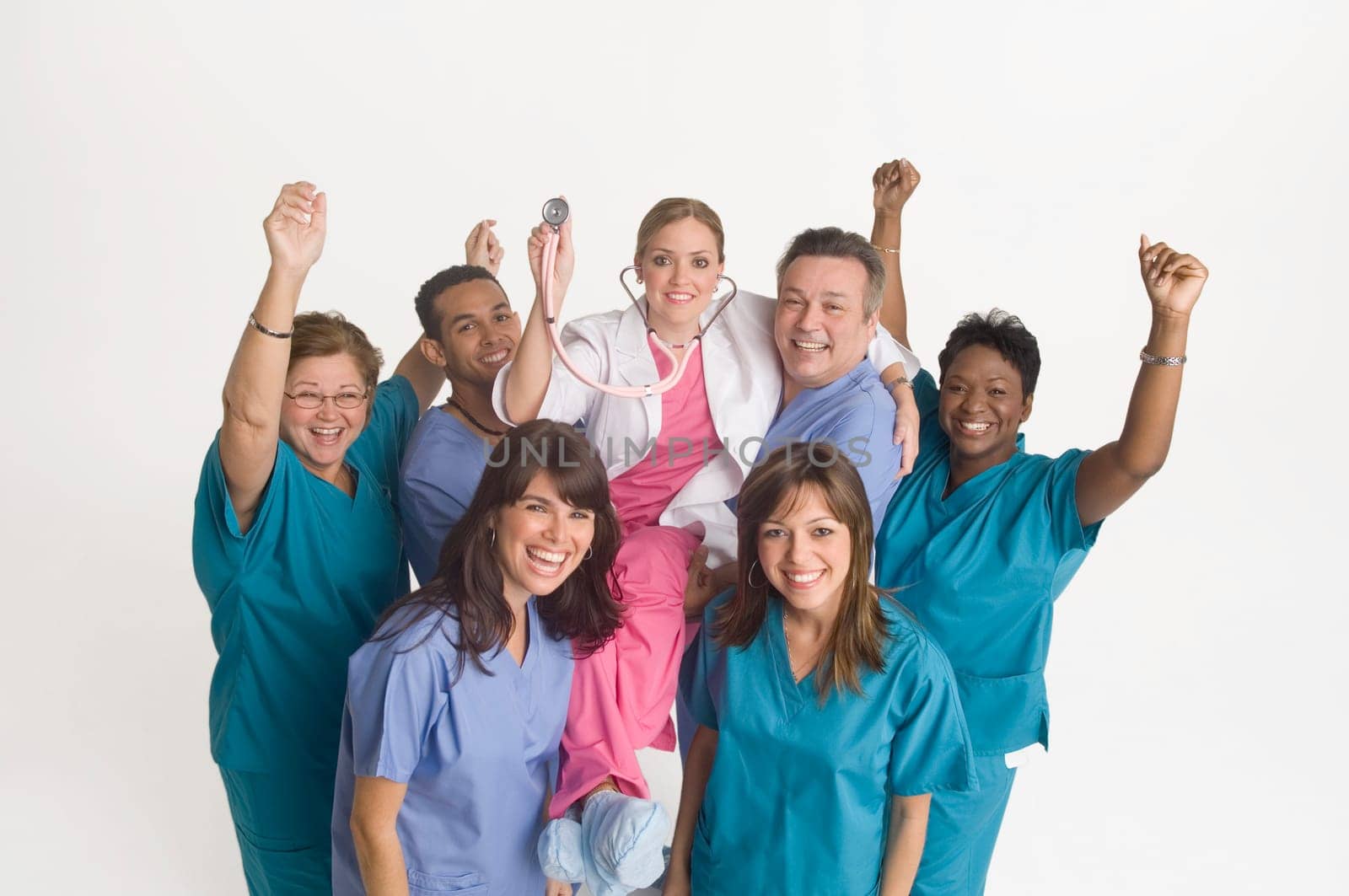 Group portrait of nurses carrying doctor