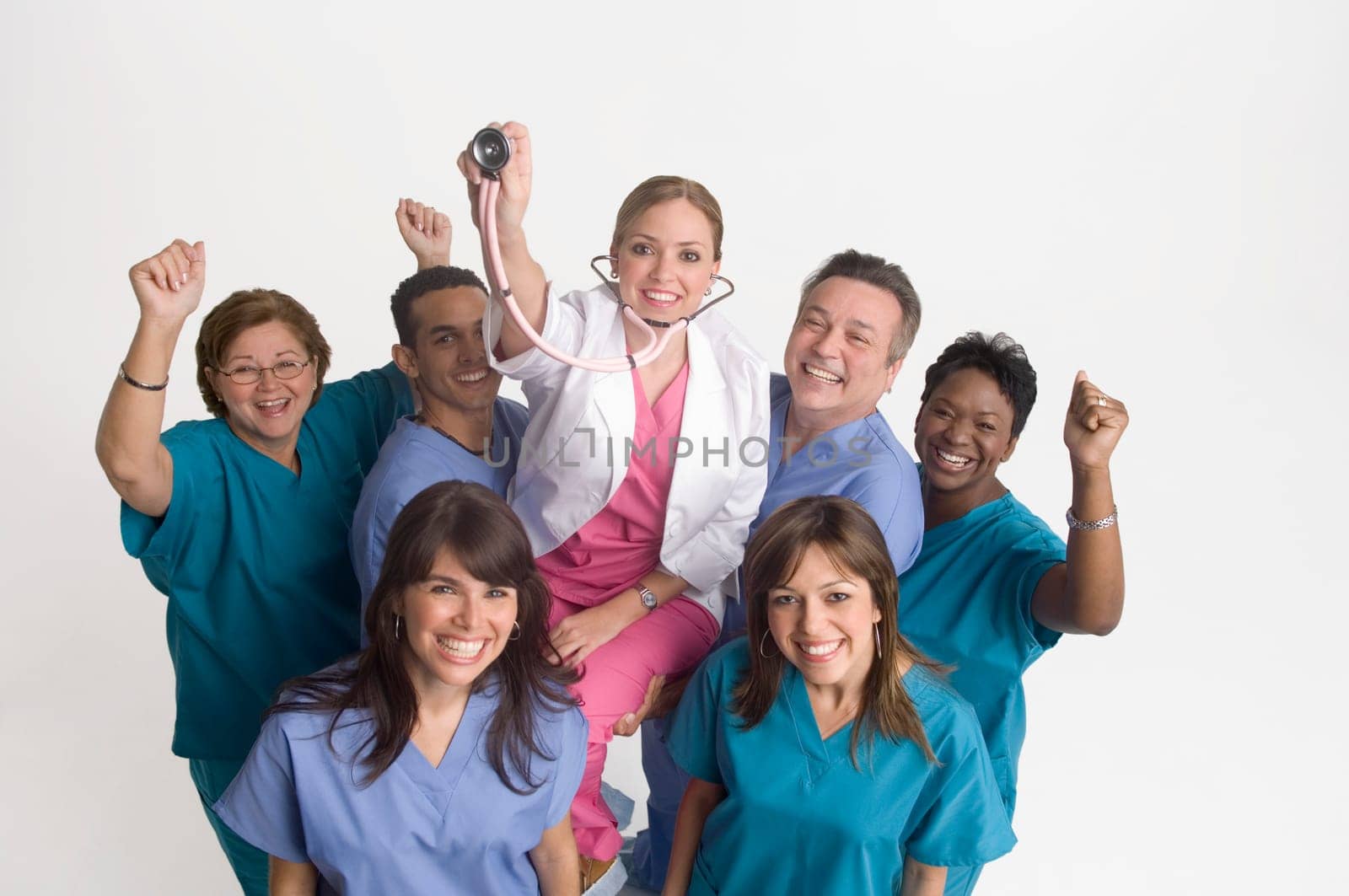 Group portrait of nurses carrying doctor