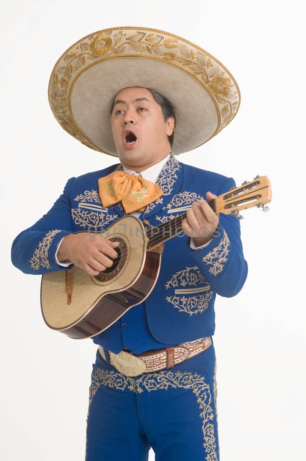 Portrait of Mariachi playing guitar and singing