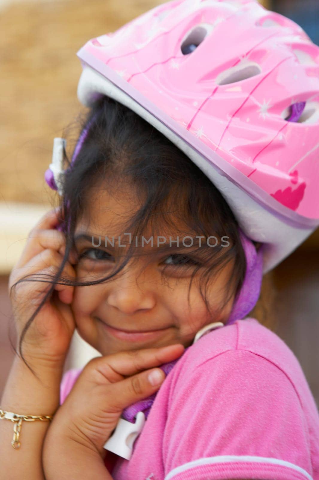 Portrait of a girl wearing a cycling helmet and smiling