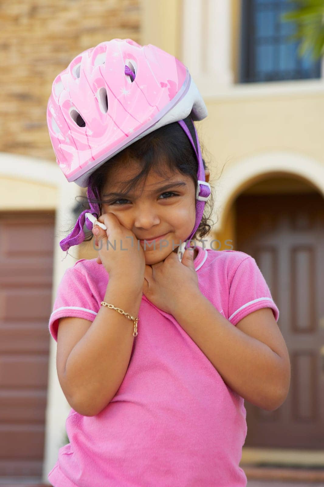 Portrait of a girl wearing a cycling helmet and smiling