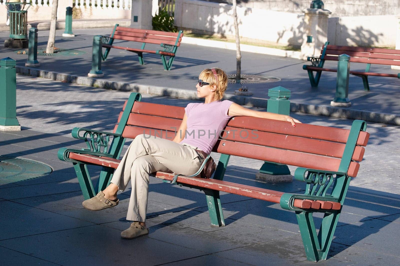 Young woman sitting on park bench