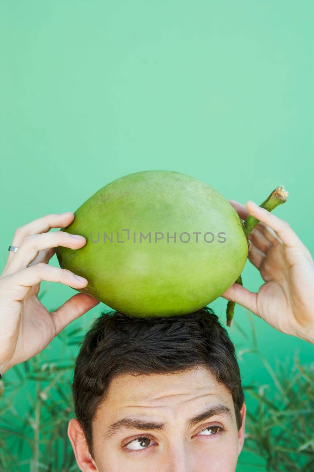 Young man balancing coconut