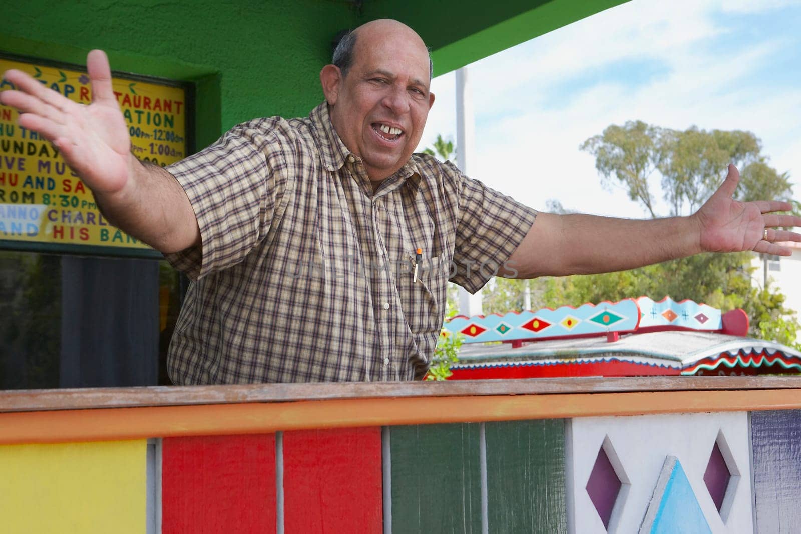 Portrait of a senior man standing with his arms outstretched