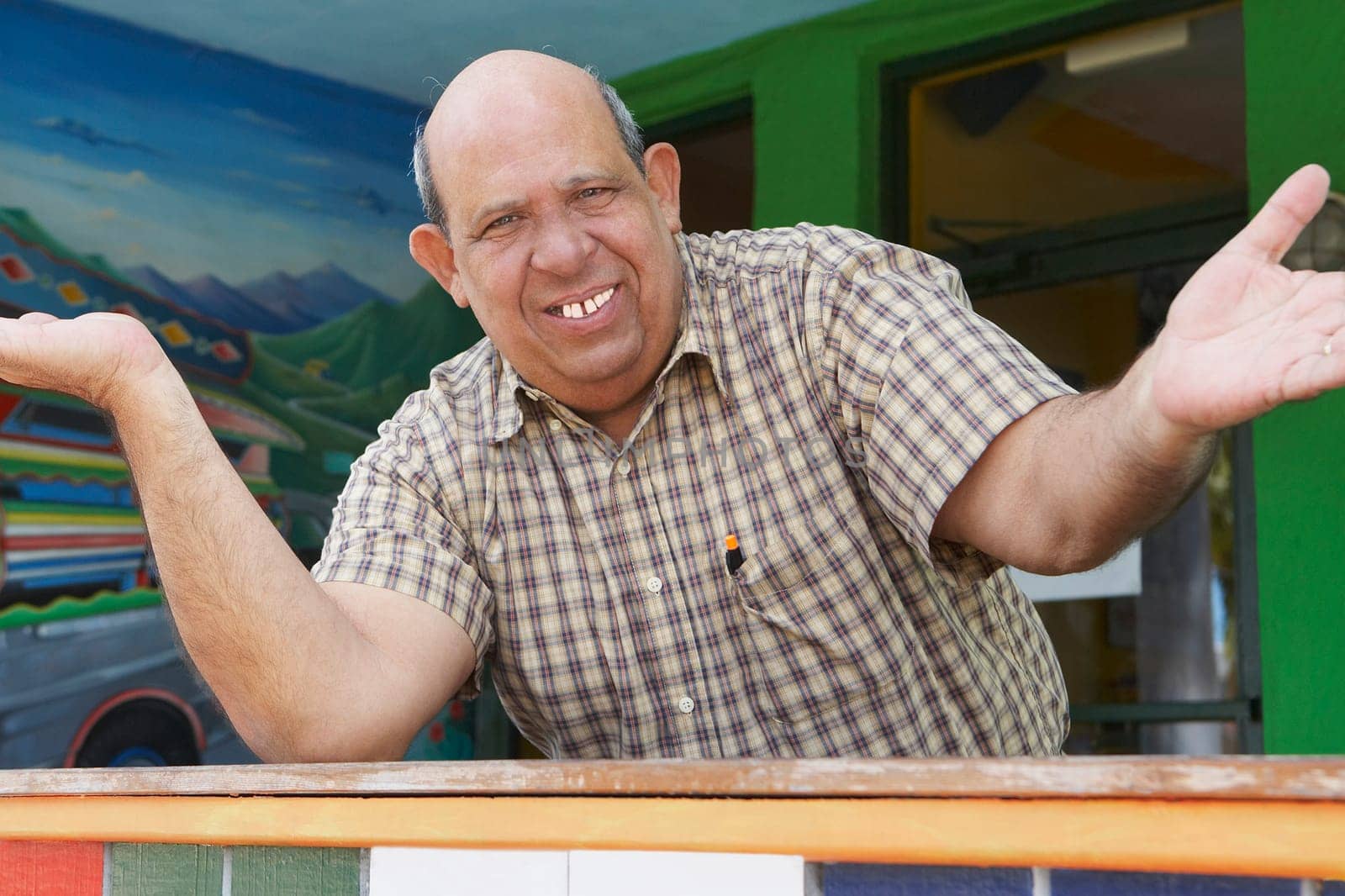 Portrait of a senior man standing with his arms outstretched