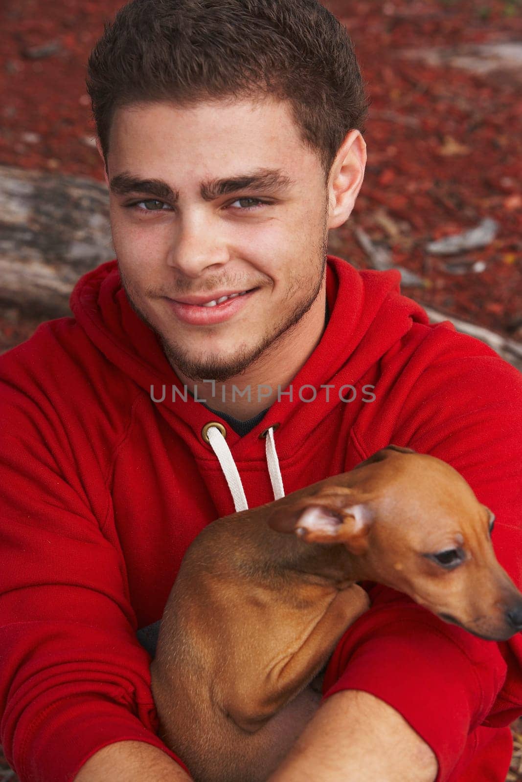 Portrait of a young man smiling with a dog