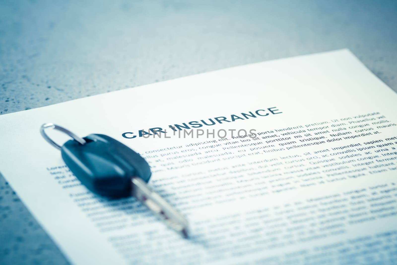 Concept of car insurance - car policy with car keys on blue tone