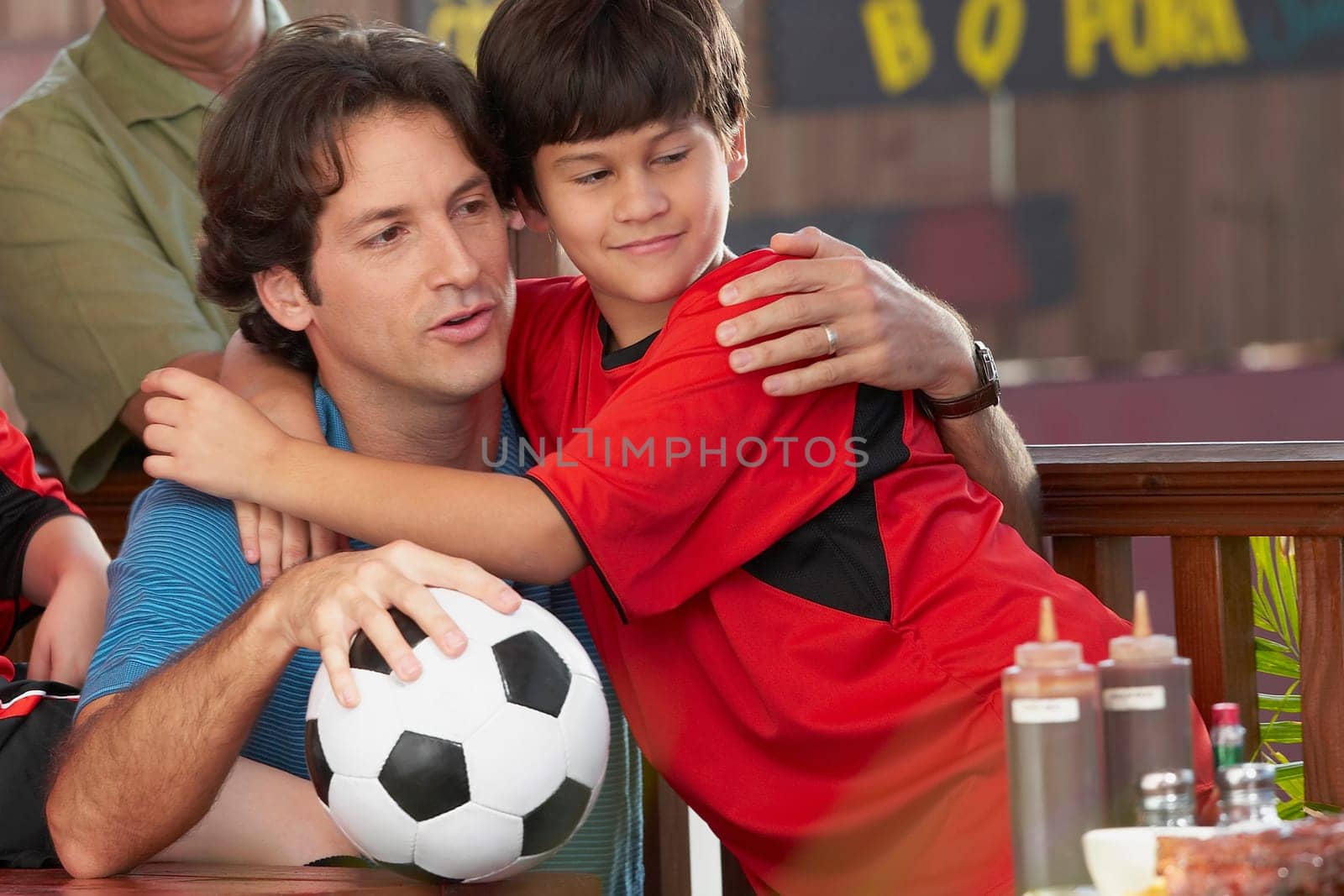 Close-up of a boy hugging his father