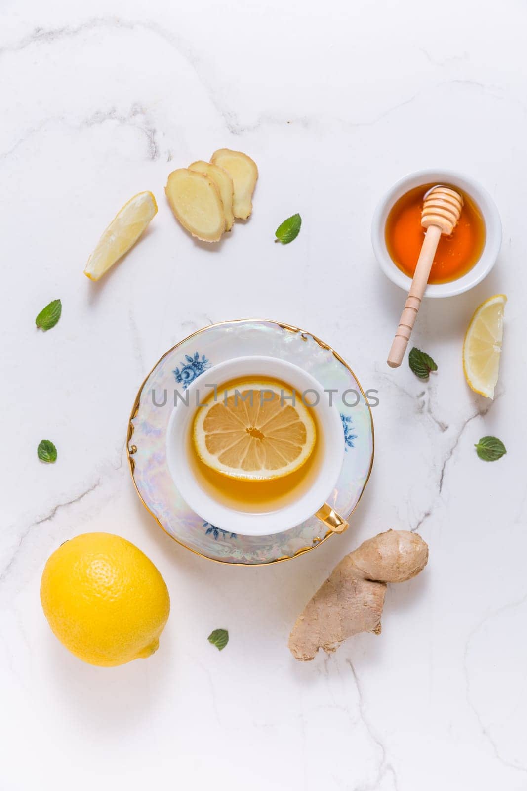 Tea with lemon, ginger and honey as natural medicine on white background