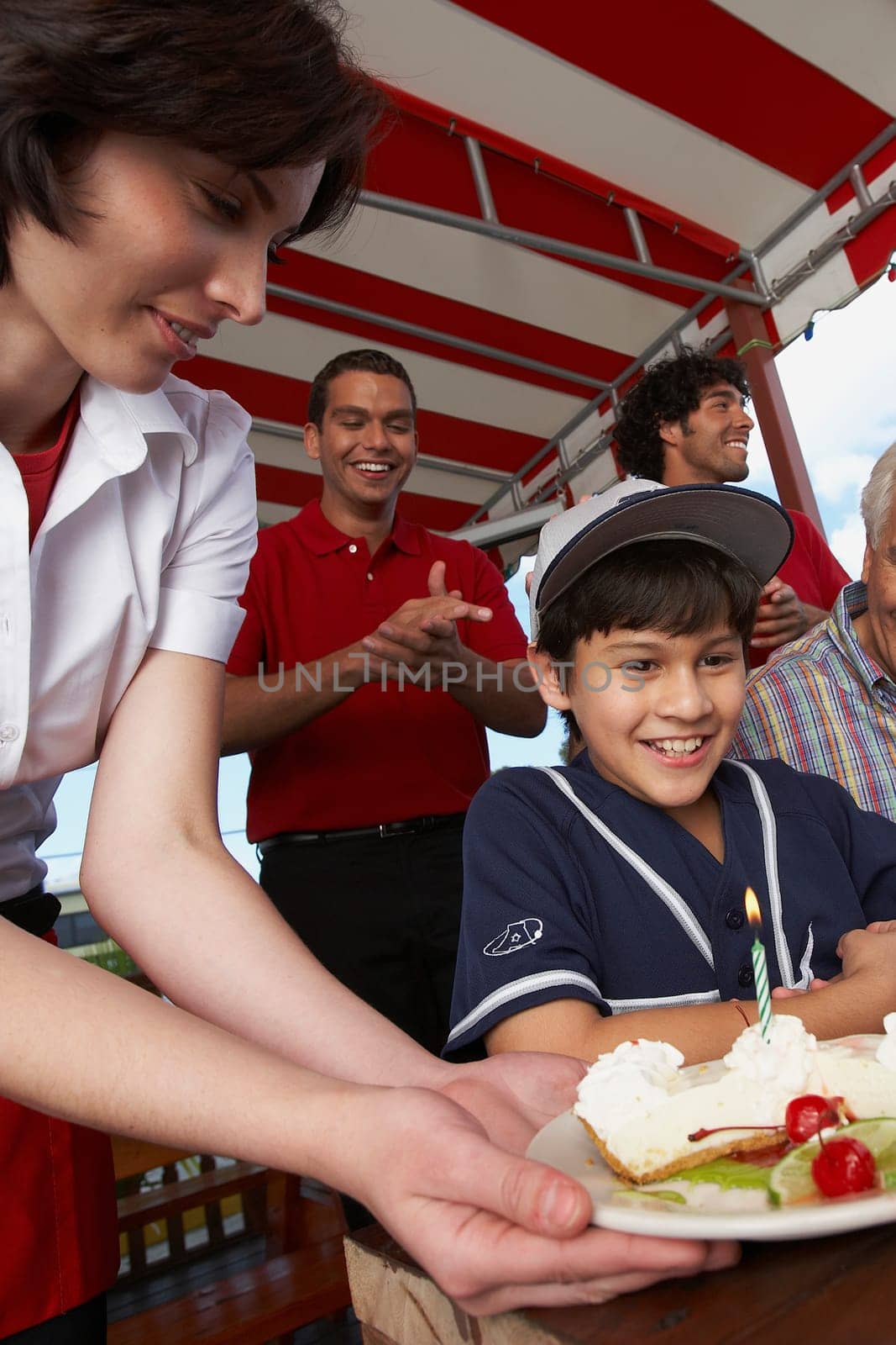 Boy celebrating his birthday with his grandfather in a restaurant