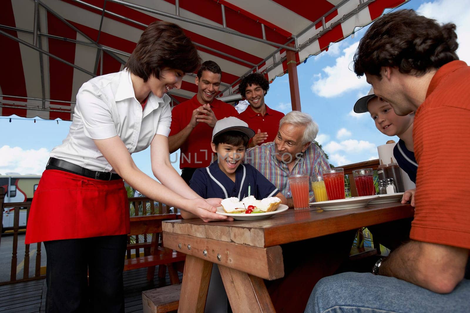Boy celebrating his birthday with his family in a restaurant