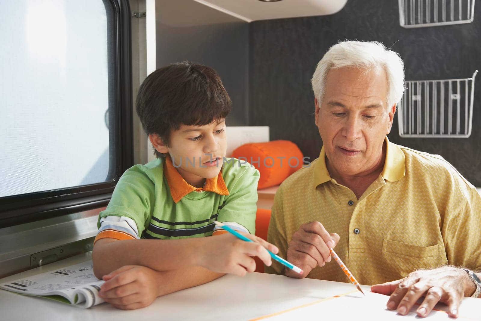 Senior man teaching his grandson