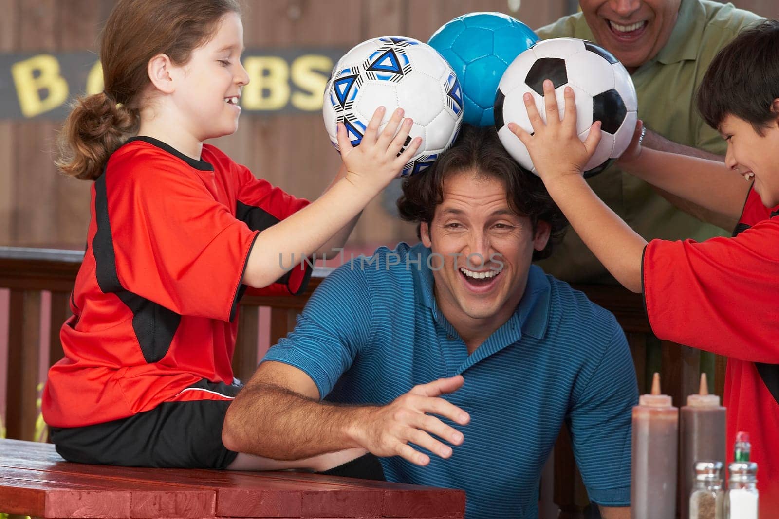 Mid adult man playing with his family in a restaurant