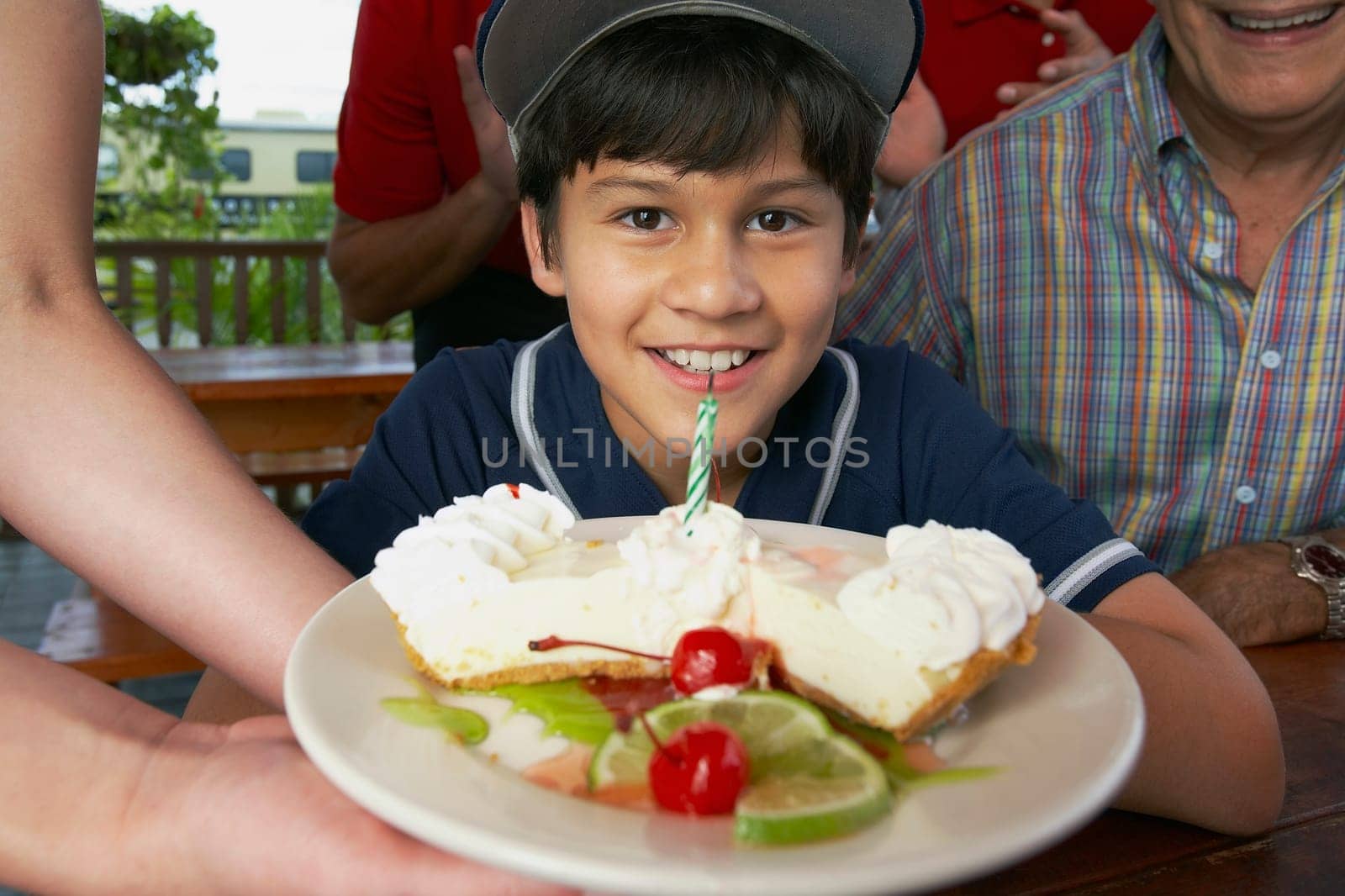 Boy celebrating his birthday with his grandfather in a restaurant
