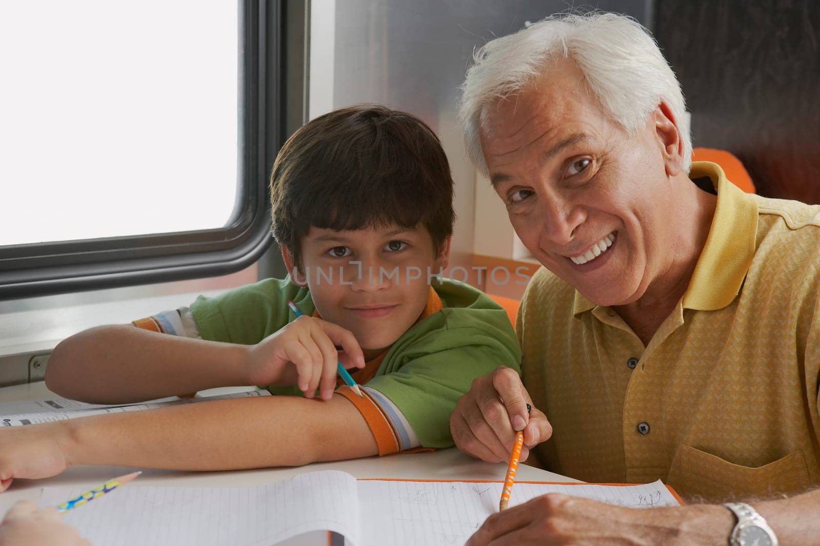 Portrait of a senior man teaching his grandson and smiling
