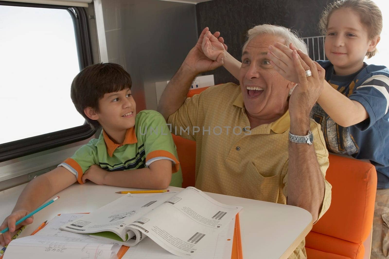 Senior man holding hands of his granddaughter and smiling