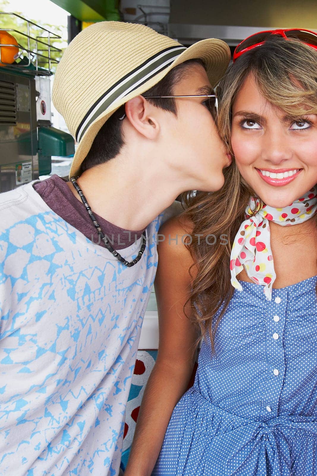 Close-up of a teenage girl being kissed by her boyfriend