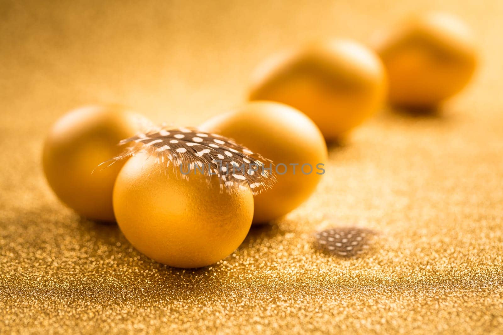 Golden eggs on golden background for Easter