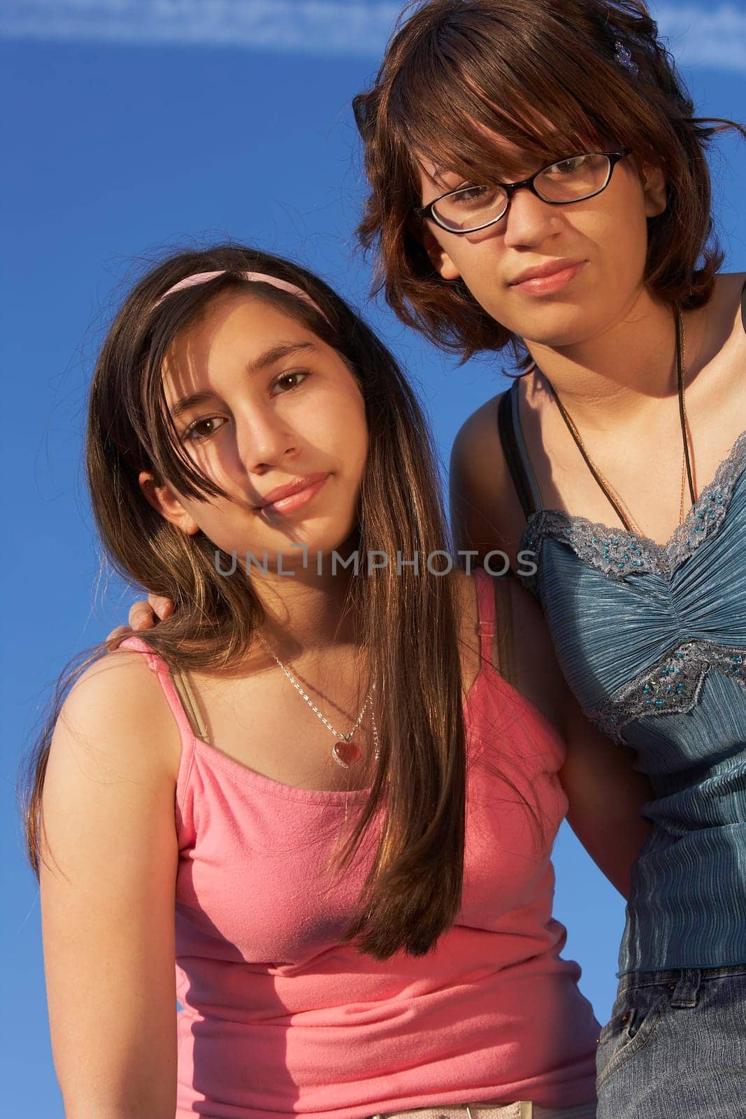 Low angle view of a teenage girl standing with her sister