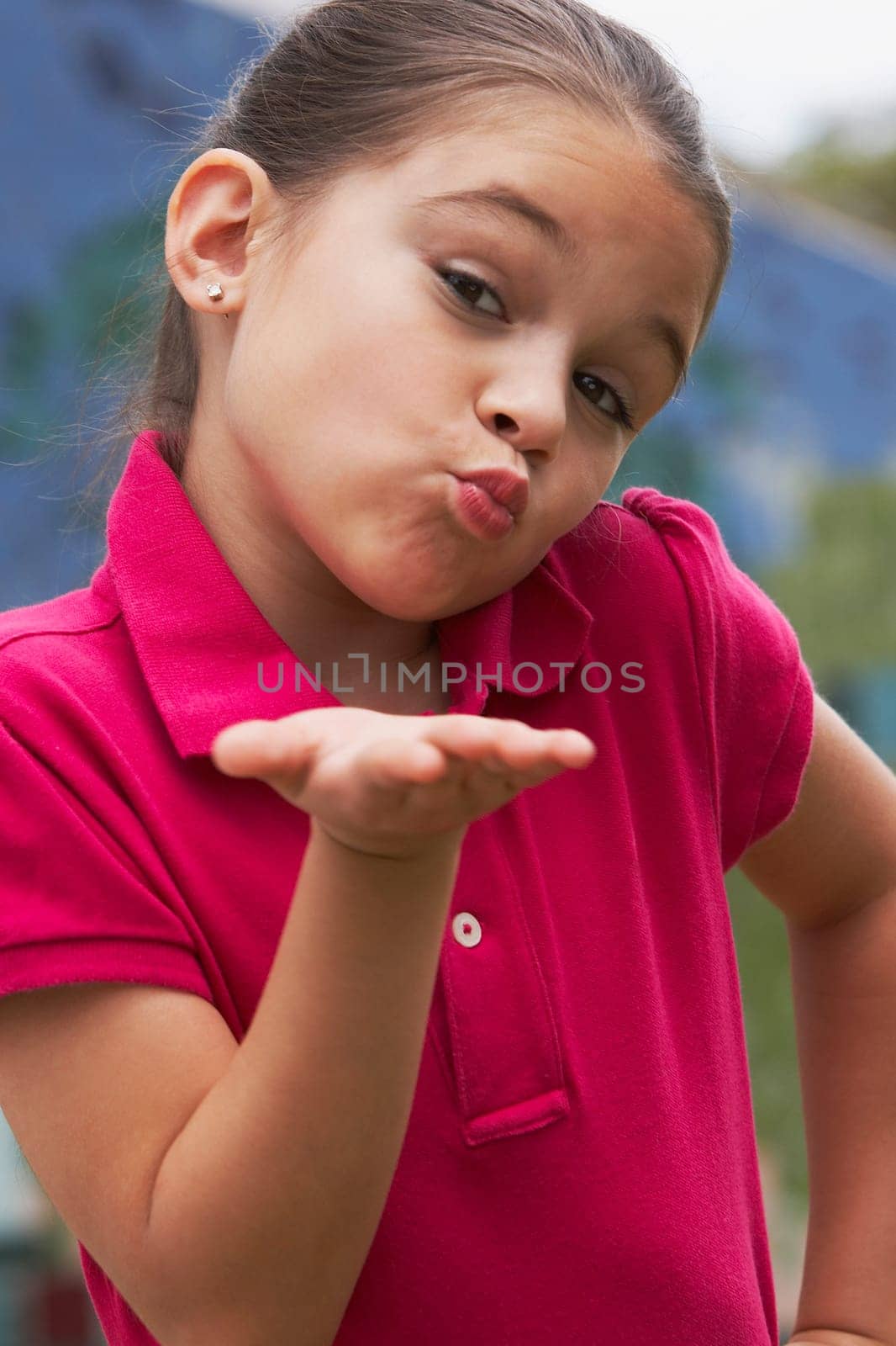 Portrait of a girl blowing kisses