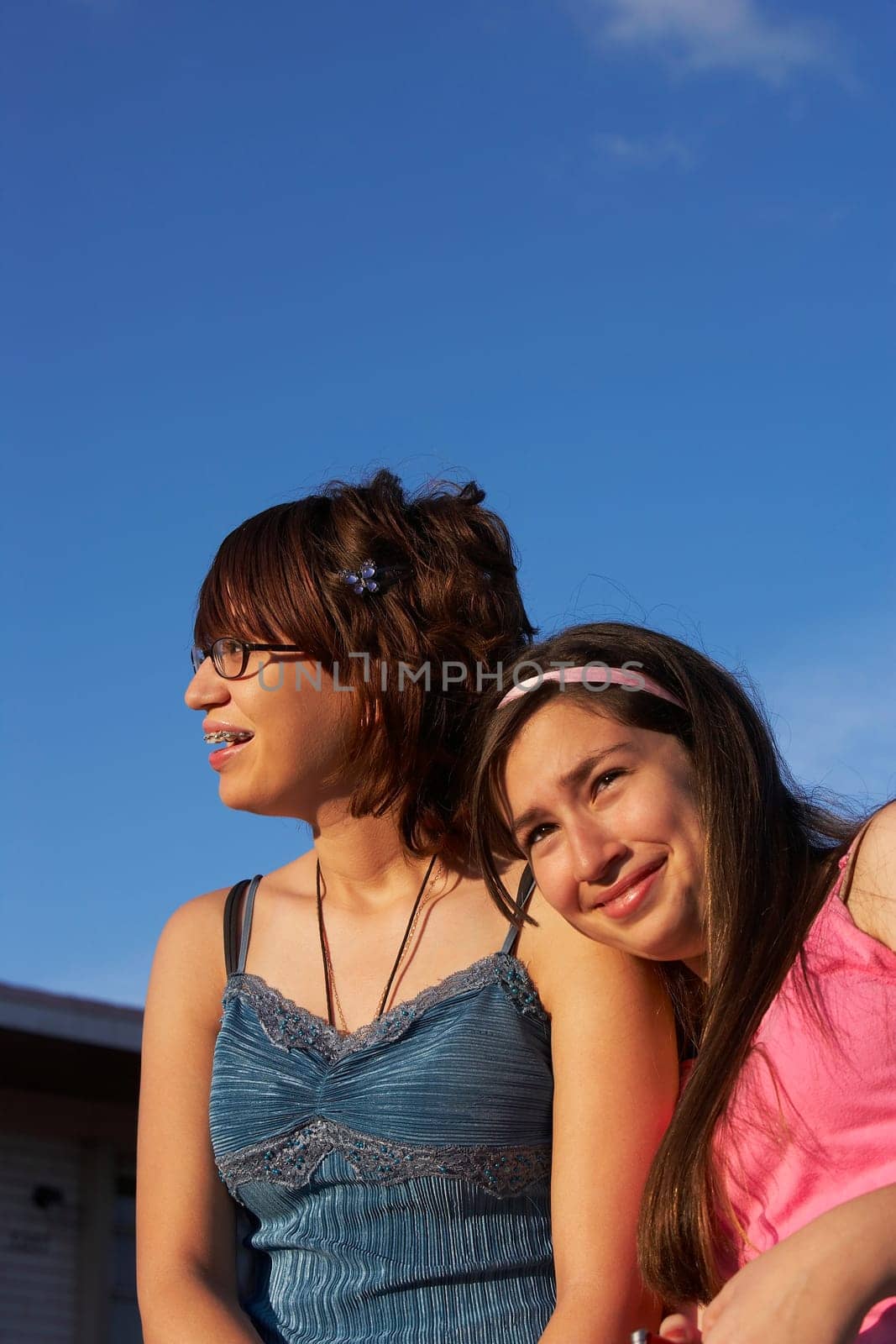 Close-up of a girl leaning on a teenage girl's shoulder