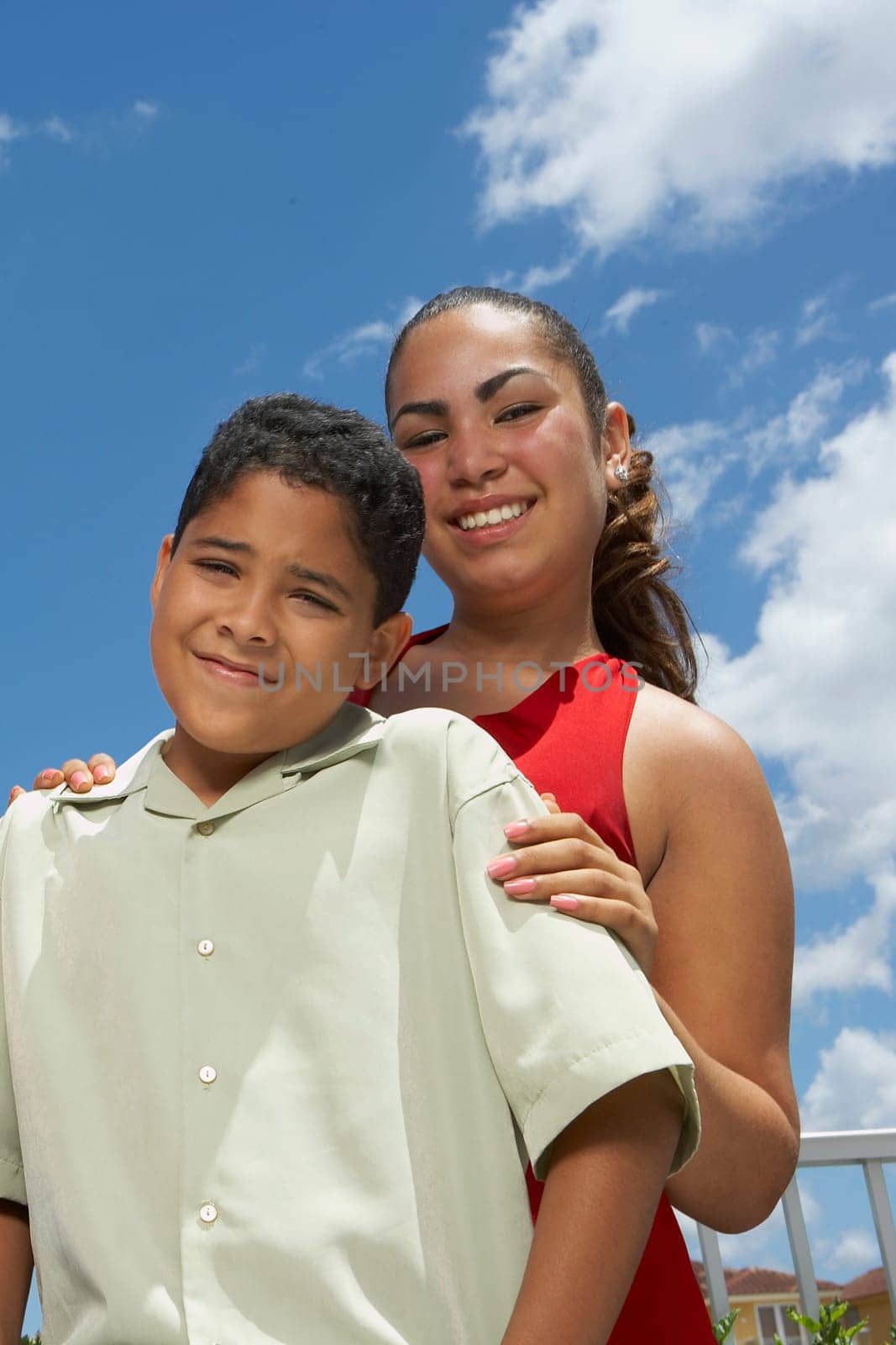 Portrait of a teenage girl and her brother smiling