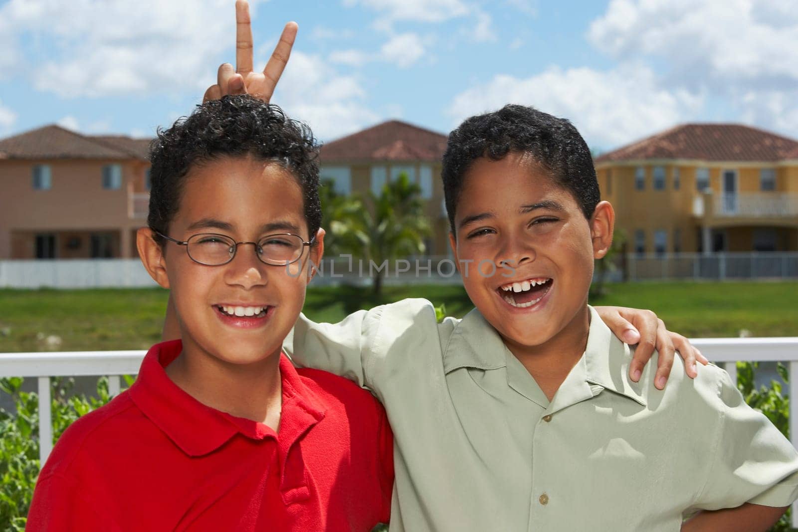 Portrait of a boy making a gesture of rabbit ears behind another boy's head
