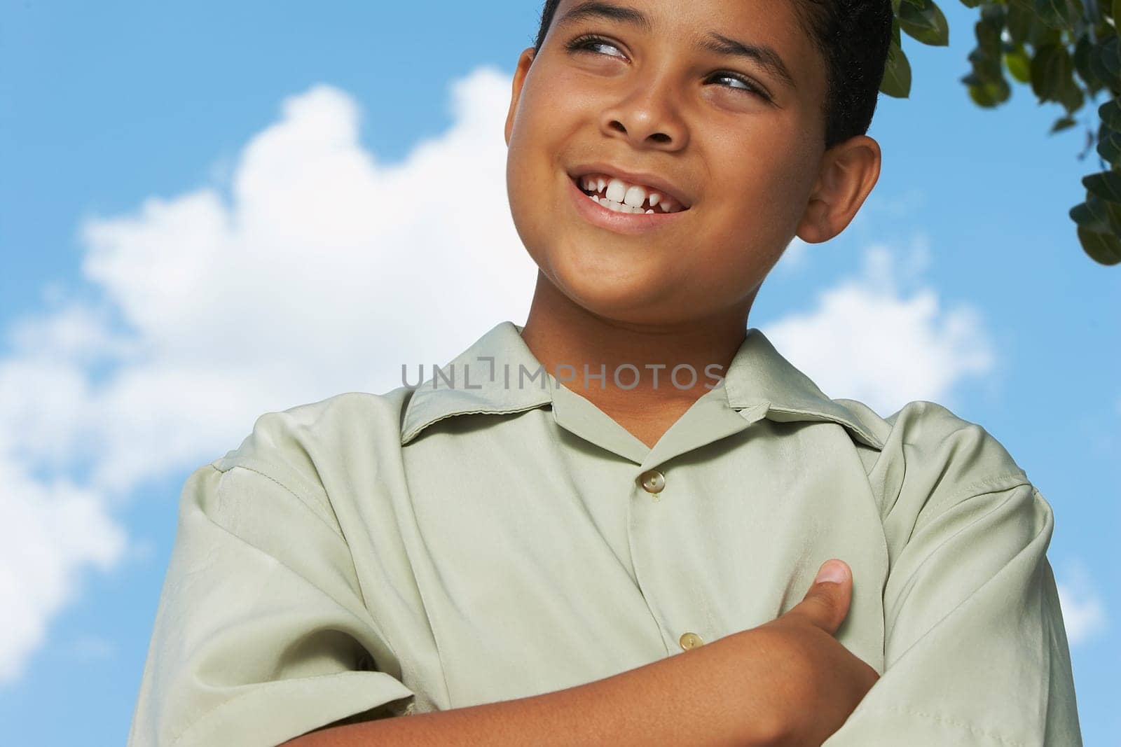Close-up of a boy with his arms crossed