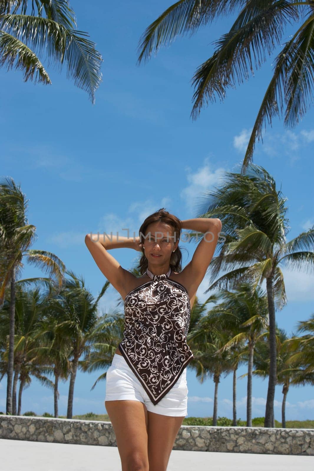 Close-up of a mature woman walking on the beach, South Beach, Miami Beach, Florida, USA