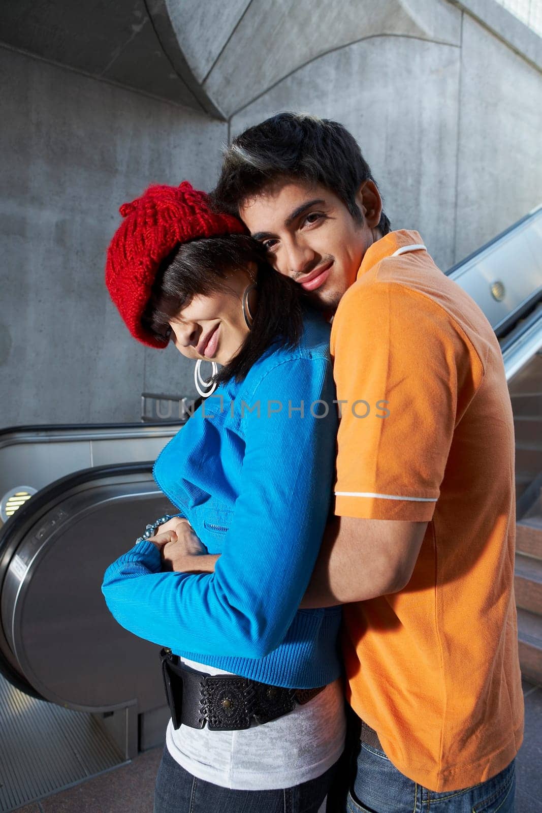Portrait of a young man embracing a young woman from behind