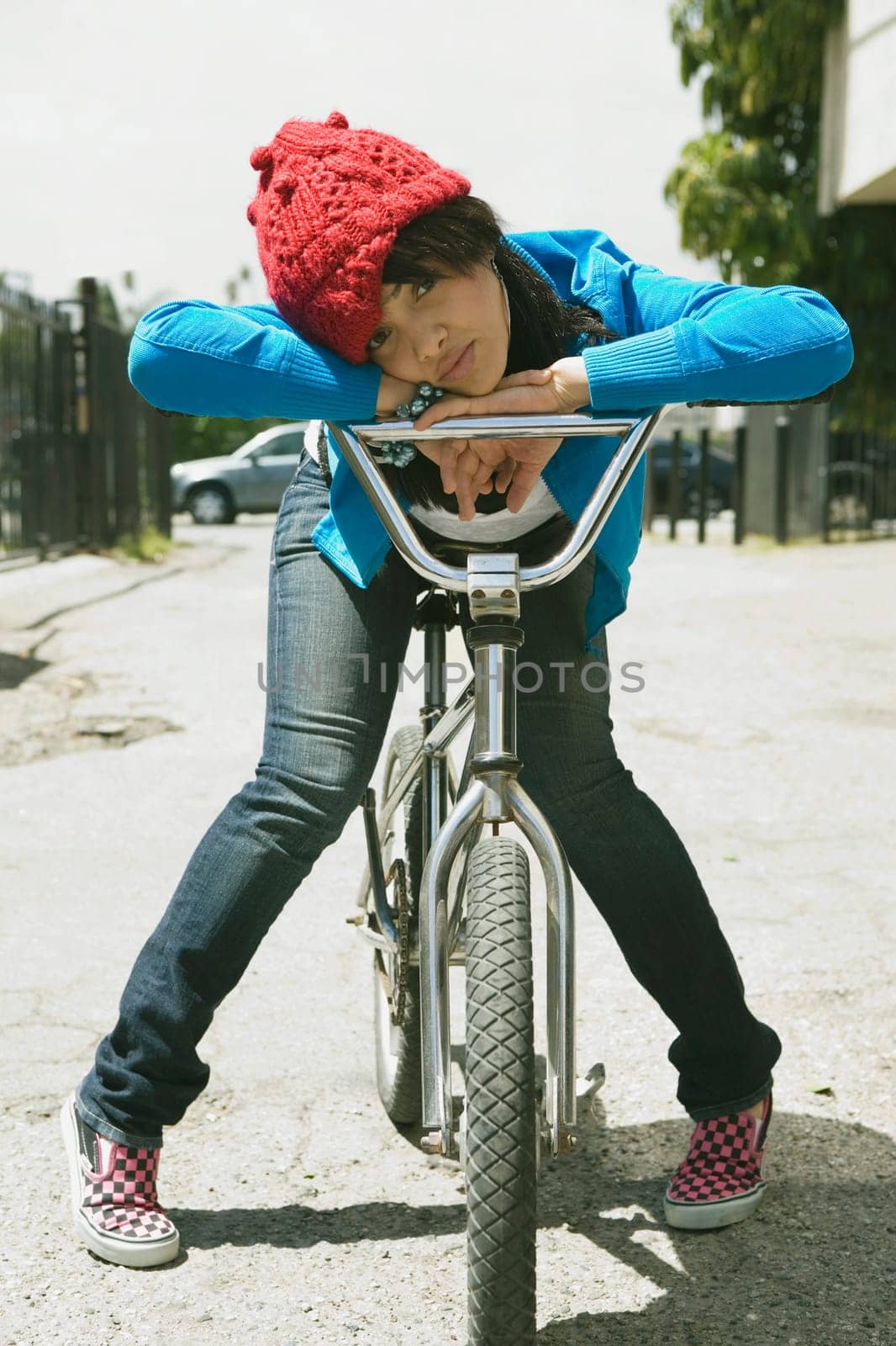 Portrait of a young woman sitting on a bicycle