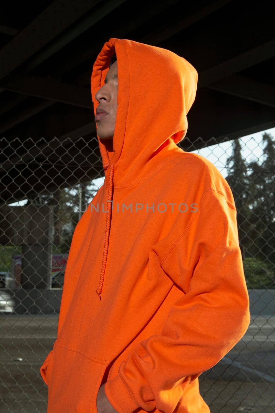 Side profile of a young man wearing a hooded shirt